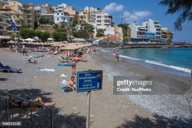 Kitroplateia Beach in Agios Nikolaos town in Crete island in Greece. This beach awarded with the Blue Flag has transparent crystal clear water in the...