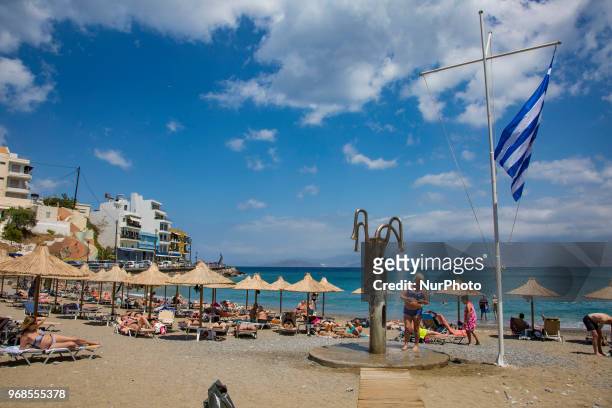 Kitroplateia Beach in Agios Nikolaos town in Crete island in Greece. This beach awarded with the Blue Flag has transparent crystal clear water in the...