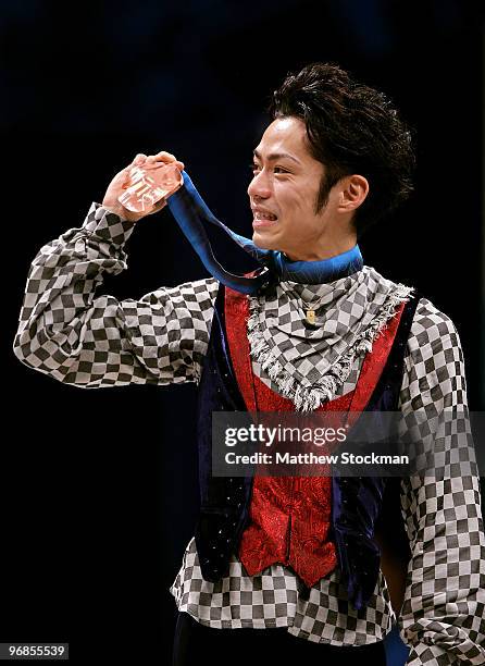 Bronze medalist Daisuke Takahashi of Japan holds his medal in the men's figure skating free skating on day 7 of the Vancouver 2010 Winter Olympics at...