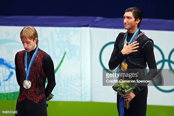 Evan Lysacek of the United States poses after winning the gold medal with silver medalist Evgeni Plushenko of Russia in the men's figure skating free...