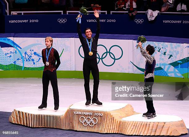 Gold medalist Evan Lysacek of the United States poses with silver medalist Evgeni Plushenko of Russia and bronze medalist Daisuke Takahashi of Japan...