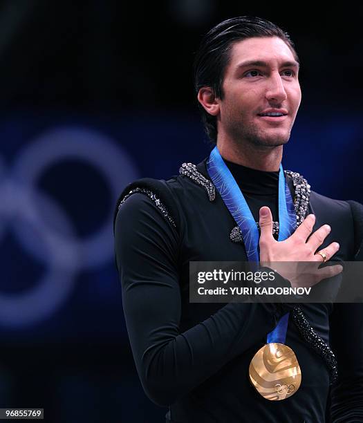 Gold medallist, US Evan Lysacek, poses during the medal ceremony after performing in the Men's Figure skating free program at the Pacific Coliseum in...