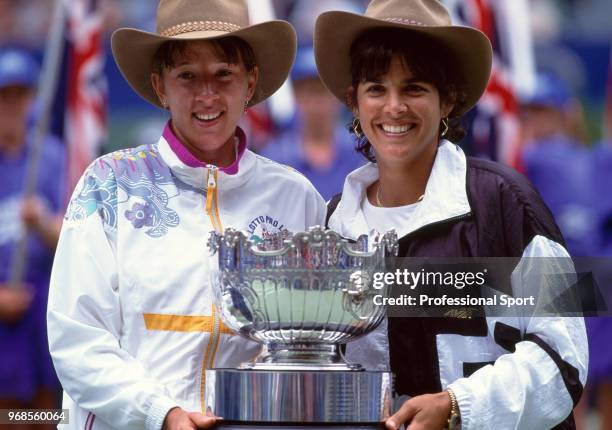 Natasha Zvereva of Belarus and Gigi Fernandez of the USA pose with the trophy after defeating Patty Fendick and Meredith McGrath both of the USA in...