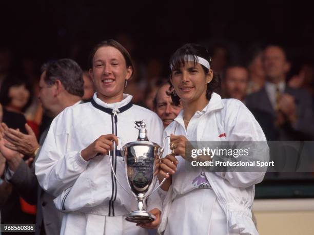 Natasha Zvereva of Belarus and Gigi Fernandez of the USA pose with the trophy after defeating Arantxa Sánchez Vicario of Spain and Jana Novotna of...