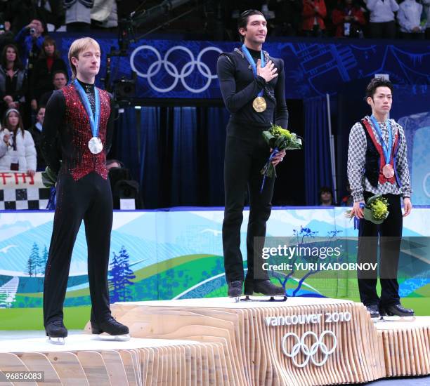 Gold medallist, US Evan Lysacek , poses on the podium, flanked by silver medallist, Russia's Evgeny Plushenko and bronze medallist, Japan's Daisuke...