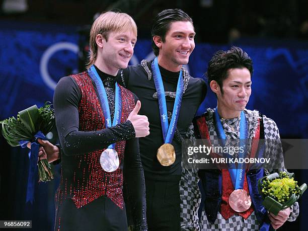 Gold medallist, US Evan Lysacek , poses on the podium, flanked by silver medallist, Russia's Evgeny Plushenko and bronze medallist, Japan's Daisuke...