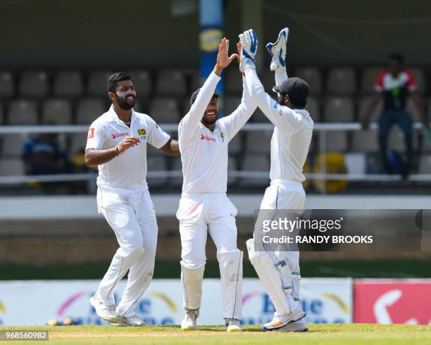 Lahiru Kumara Kusal Mendis and Niroshan Dickwella of Sri Lanka celebrate the dismissal of Shai Hope of West Indies during day 1 of the 1st Test...
