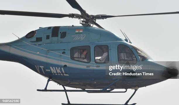 Congress president Rahul Gandhi waves from helicopter after addressing 'Kisan Samriddhi Sankalp' rally in Pipliya Mandi at Khokhra on June 6, 2018 in...