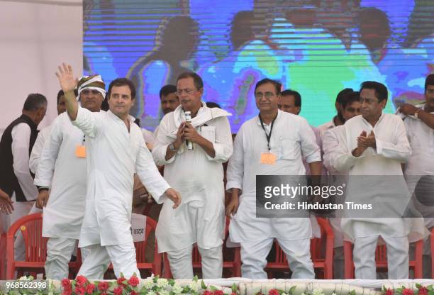 Congress president Rahul Gandhi waves at supporters as Arun Yadav, Deepak Bavaria , Kamal Nath looks on during 'Kisan Samriddhi Sankalp' rally in...