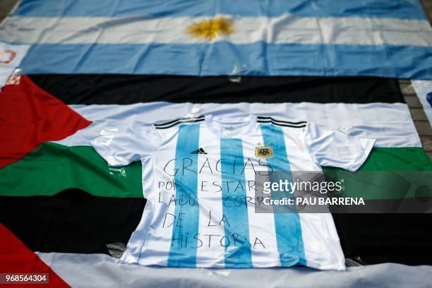 Picture shows a jersey of Argentina's national football team with a text reading "Thanks for being on the right side of history" as pro-Palestine...