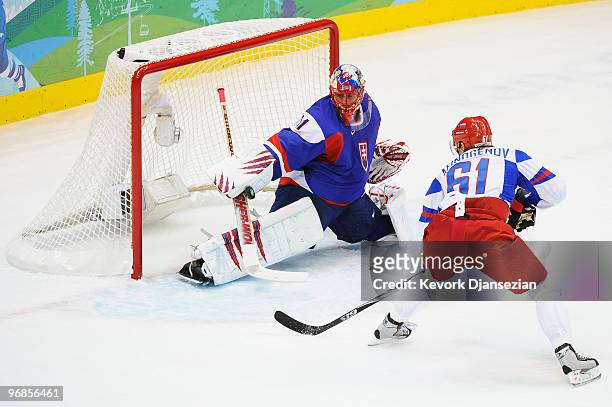 Goalkeeper Peter Budaj of Slovakia saves the shot from Maxim Afinogenov of Russian Federation during the ice hockey men's preliminary game between...