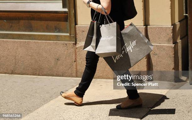 Woman walks out of Lord & Taylor's flagship store on 5th Avenue in Manhattan on June 6, 2018 in New York City. The 192-year-old chain owned by...