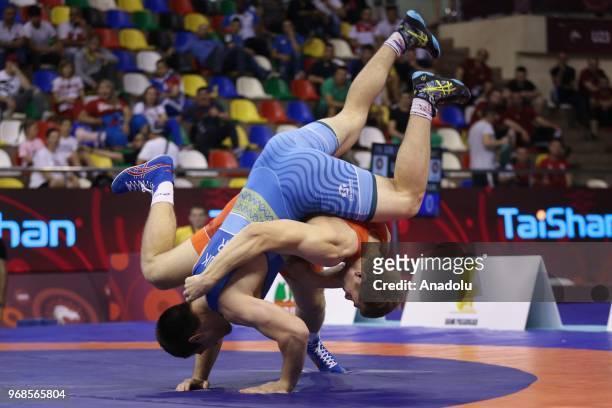 Aleksandr Golovin of Russia in action against Vladen Kozliuk of Ukraine during third day of Mens final greco roman style 97kg category match within...