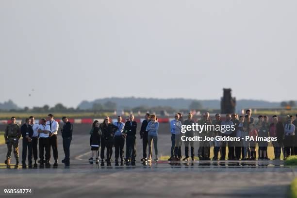 Staff and families watch as Britain's F-35B jets arrive at RAF Marham in Norfolk.