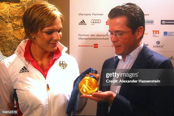 Gold medalist Maria Riesch of Germany poses with German Defense Minister Karl-Theodor zu Guttenberg and her gold medal for the women's Super...
