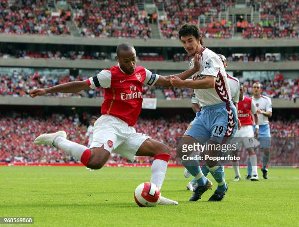 Thierry Henry of Arsenal is challenged by Liam Ridgewell of Aston Villa during the Barclays Premiership match between Arsenal and Aston Villa at The...