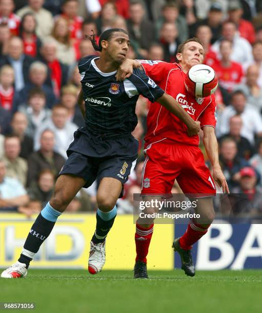 Anton Ferdinand of West Ham United battles for the ball with Craig Bellamy of Liverpool during the Barclays Premiership match between Liverpool and...