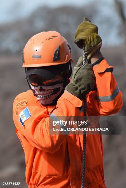 Volunteer firefighter searches for victims of Sunday's Fuego Volcano eruption in Alotenango, a municipality in Sacatepequez Department, southwest of...