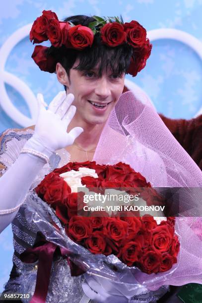 Johnny Weir wave to the public at the kiss and cry area before listening to his results after performing in the Men's Figure skating free program at...