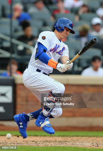 Brandon Nimmo of the New York Mets fouls a ball off his foot during the eighth inning of a game against the Baltimore Orioles at Citi Field on June...