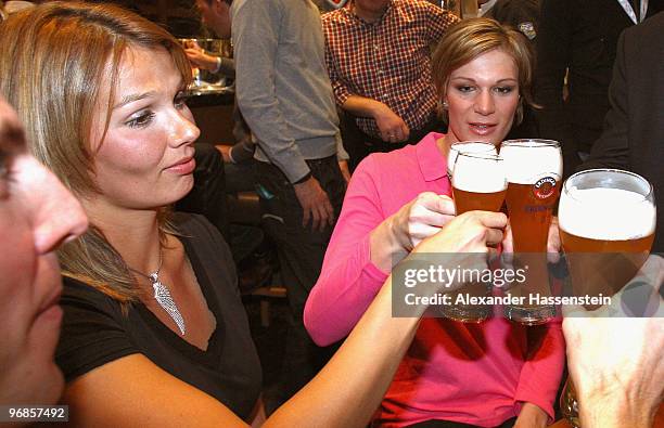 Gold medalist Maria Riesch of Germany celebrates her gold medal for the women's Super Combined with Olympic gold medalist swimmer Franziska van...