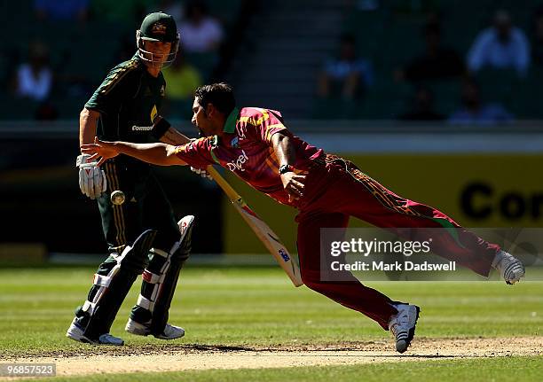 Ravi Rampaul of the West Indies dives to field from his own bowling during the Fifth One Day International match between Australia and the West...