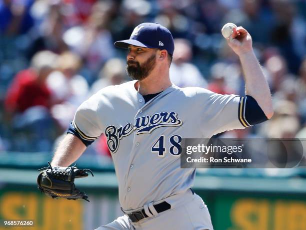 Boone Logan of the Milwaukee Brewers pitches against the Cleveland Indians during the seventh inning at Progressive Field on June 6, 2018 in...