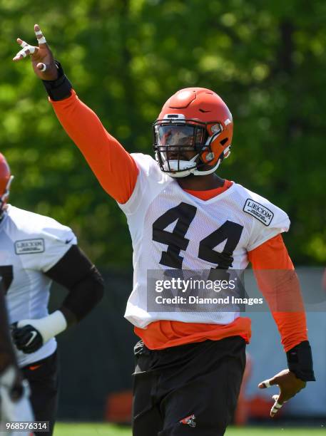 Defensive lineman Nate Orchard of the Cleveland Browns gestures toward the sideline as he stretches during an OTA practice at the Cleveland Browns...