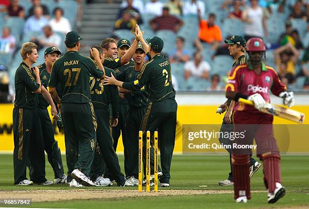 Ryan Harris of Australia is congratulated by team-mates after getting the wicket of Narsingh Deonarine of the West Indies during the Fifth One Day...