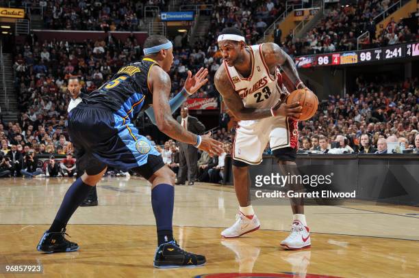 LeBron James of the Cleveland Cavaliers looks to drive to the basket against Carmelo Anthony of the Denver Nuggets during the game on February 18,...