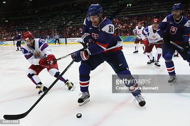 Marian Hossa of Slovakia battles for the puck against Sergey Fedorov of Russia during the ice hockey men's preliminary game between Slovakia and...