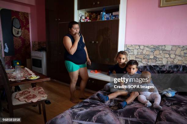 A mother with her three children at her house in Lunik IX., News Photo