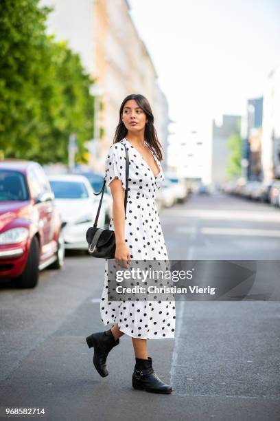 Model Alyssa Cordes wearing white dress with black dot print Gestuz, the Kooples leather ankle boots,, APC bag wearing on June 6, 2018 in Berlin,...