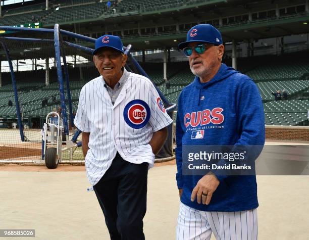 Hall of Fame football player Joe Namath is given a tour of Wrigley Field by Joe Maddon of the Chicago Cubs before the game between the Chicago Cubs...
