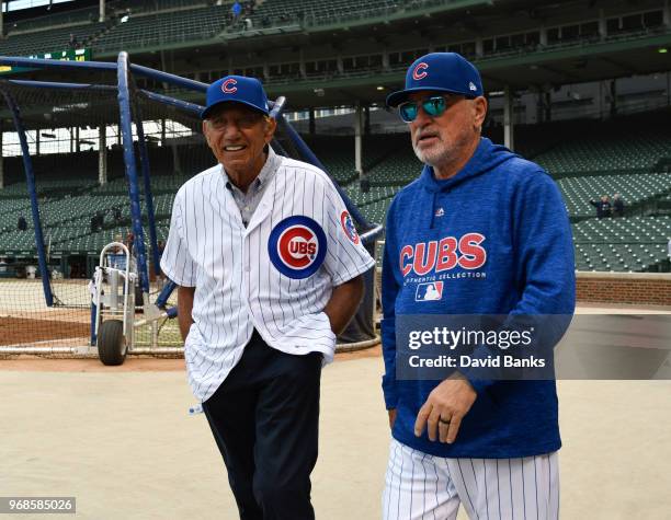 Hall of Fame football player Joe Namath is given a tour of Wrigley Field by Joe Maddon of the Chicago Cubs before the game between the Chicago Cubs...