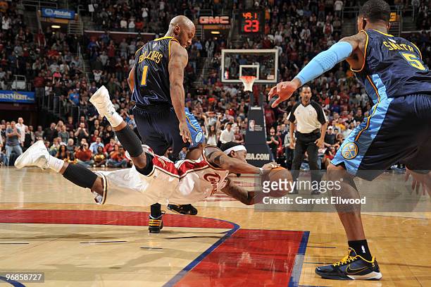 Daniel Gibson of the Cleveland Cavaliers dives for the ball against Chauncey Billups and J.R. Smith of the Denver Nuggets during the game on February...
