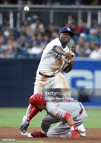 Jose Pirela of the San Diego Padres throws over Billy Hamilton of the Cincinnati Reds as he turns a double play during the seventh inning of a...