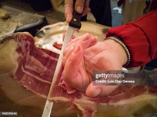 iberian ham cut with knife. - serrano ham foto e immagini stock