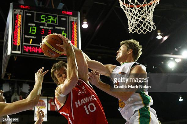 Larry Davidson of the Hawks and Cameron Tovey of Townsville contest possession during game one of the NBL semi final series between the Wollongong...