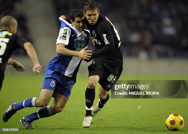 Porto's midfielder from Argentina Diego Valeri tussles with Academica's midfielder Diogo Gomes during their Portuguese League Cup semi-final football...