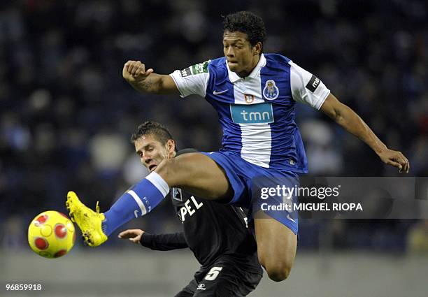 Porto's midfielder from Colombia Fredy Guarin vies with Academica's midfielder Brazilian Diogo Gomes during their Portuguese League Cup semi-final...