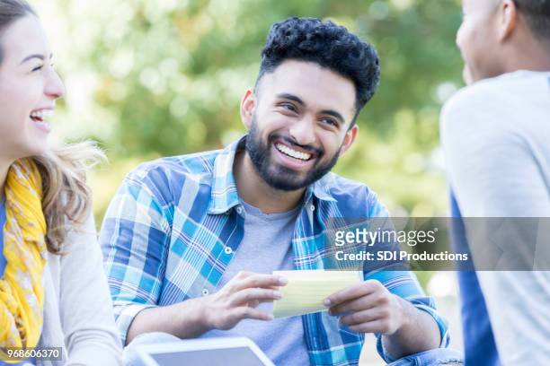 happy male college student studying with friends - flash card stock pictures, royalty-free photos & images
