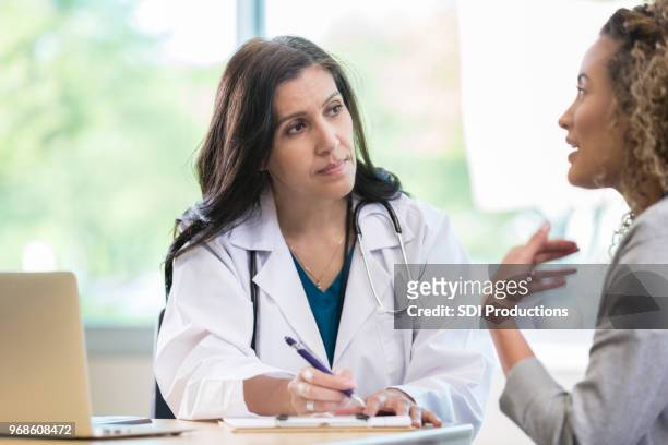 compassionate doctor listens patient - doctor listener imagens e fotografias de stock