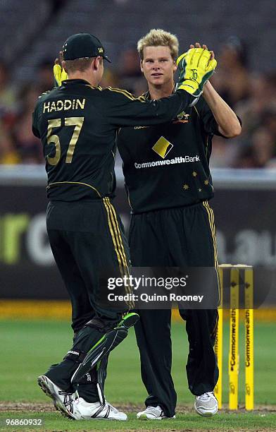 Steven Smith of Australia is congratulated by Brad Haddin after getting the wicket of Ravi Rampaul of the West Indies during the Fifth One Day...