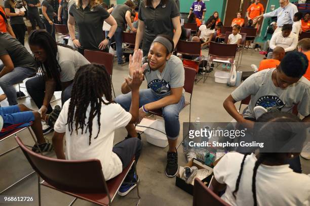 Maya Moore of the Minnesota Lynx participates in a community event giving away shoes and socks at Payne Elementary in Washington, DC on Jun 6, 2018....