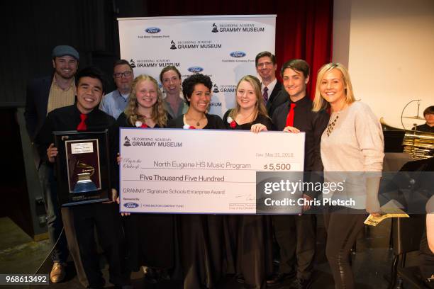 The GRAMMY Museum's Patrick Lundquist and Kendal Ford's Amy Newport present North Eugene High students and teachers including Patrick Feng ,...