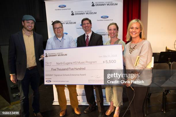 The GRAMMY Museum's Patrick Lundquist , and Amy Newport with Kendall Ford of Eugene present North Eugene High School Assistant Principal Scott...