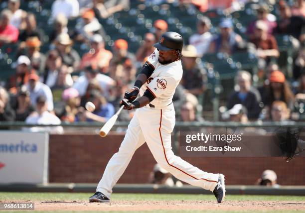 Alen Hanson of the San Francisco Giants hits a two-run home run to tie the game in the bottom of the ninth inning against the Arizona Diamondbacks at...