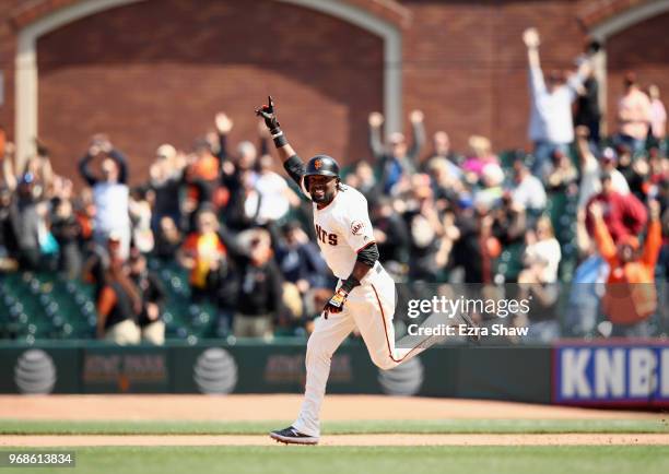 Alen Hanson of the San Francisco Giants rounds the bases after he hit a two-run home run to tie the game in the bottom of the ninth inning against...