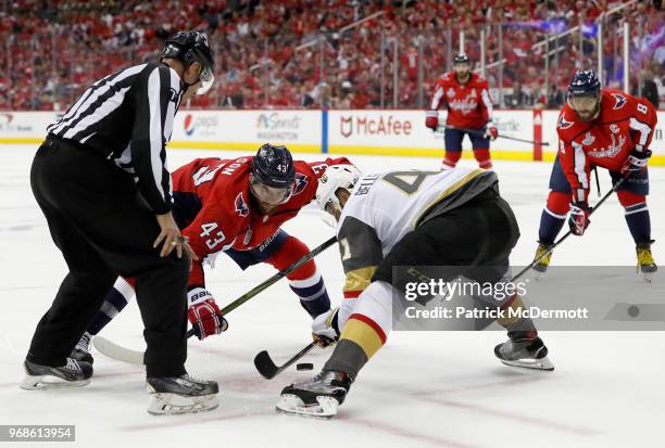 Tom Wilson of the Washington Capitals faces off against Pierre-Edouard Bellemare of the Vegas Golden Knights during Game Four of the 2018 NHL Stanley...